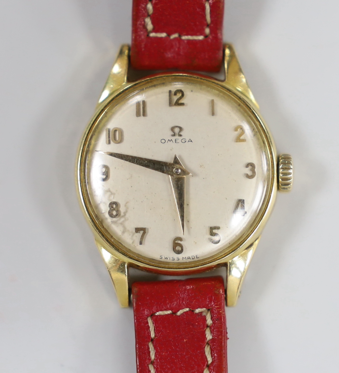 A lady's 18k Omega manual wind wrist watch, on a leather strap with 9ct gold buckle with Omega insignia, gross weight 15.9 grams.